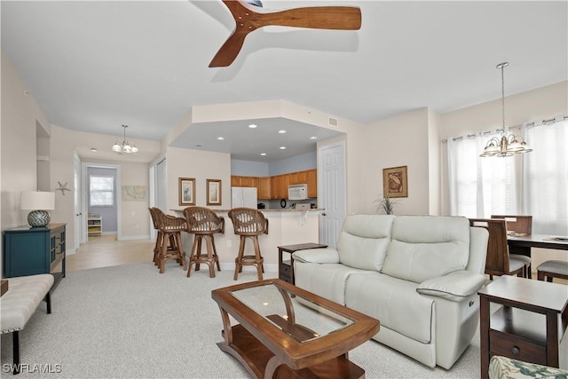 3724 Agualinda Blvd Unit 201, Cape Coral, FL 33914 - living room with a chandelier, light carpet, and a ceiling fan