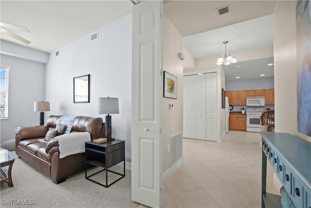 3724 Agualinda Blvd Unit 201, Cape Coral, FL 33914 - living room featuring ceiling fan, a chandelier, healthy amount of natural light, and light tile patterned floors