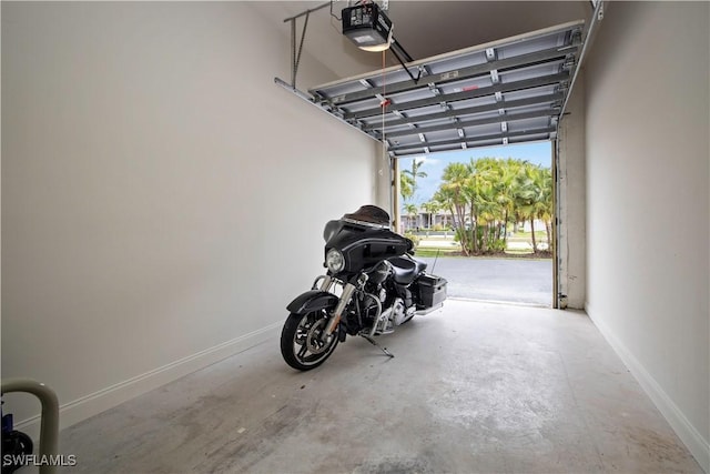 3724 Agualinda Blvd Unit 201, Cape Coral, FL 33914 - garage featuring a garage door opener and baseboards