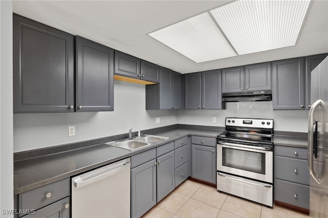 3140 Seasons Way Unit 510, Estero, FL 33928 - kitchen with stainless steel appliances, under cabinet range hood, light tile patterned floors, and dark countertops