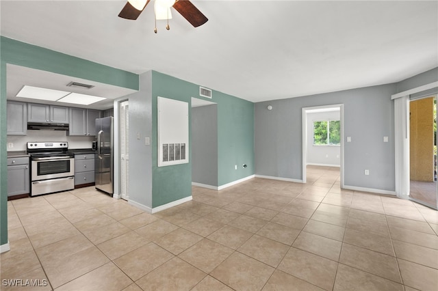 3140 Seasons Way Unit 510, Estero, FL 33928 - kitchen featuring stainless steel appliances, under cabinet range hood, gray cabinets, ceiling fan, and light tile patterned floors