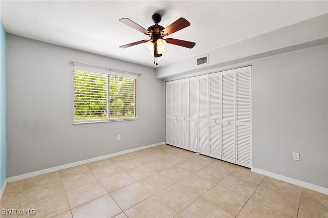 3140 Seasons Way Unit 510, Estero, FL 33928 - unfurnished bedroom with a closet, a ceiling fan, and light tile patterned flooring