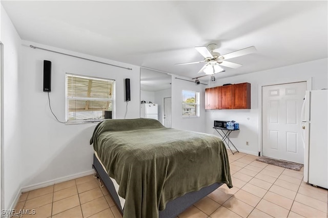 2200 50th St SW, Naples, FL 34116 - bedroom with freestanding refrigerator, light tile patterned floors, and a ceiling fan