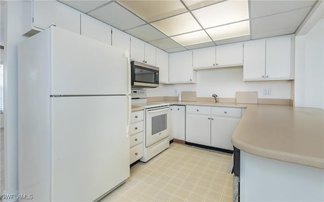 6884 Sandtrap Dr Unit 4, Fort Myers, FL 33919 - kitchen with white appliances, light countertops, white cabinets, and a drop ceiling