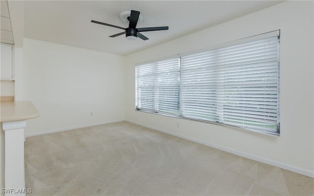 6884 Sandtrap Dr Unit 4, Fort Myers, FL 33919 - spare room featuring light carpet and a ceiling fan