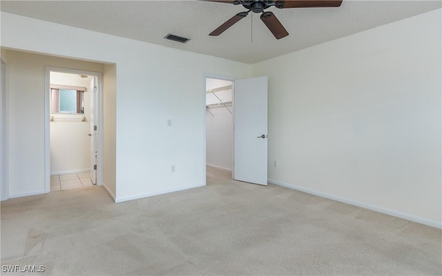 6884 Sandtrap Dr Unit 4, Fort Myers, FL 33919 - unfurnished bedroom featuring carpet flooring, a spacious closet, a closet, connected bathroom, and ceiling fan