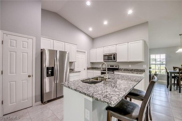 506 NE 2nd Place, Cape Coral, FL 33909 - kitchen with appliances with stainless steel finishes, lofted ceiling, light tile patterned floors, light stone countertops, and recessed lighting