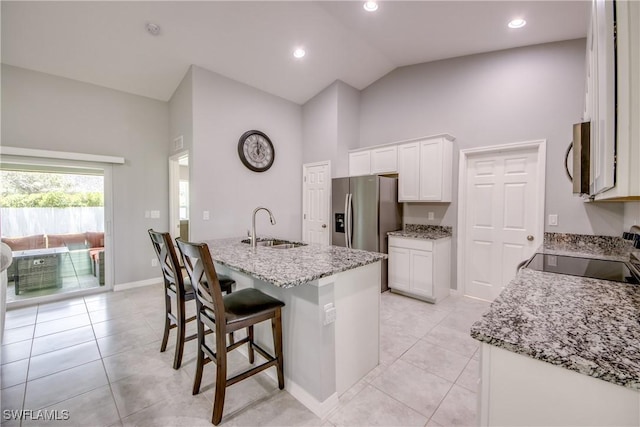 506 NE 2nd Place, Cape Coral, FL 33909 - kitchen featuring stainless steel appliances, white cabinets, light tile patterned floors, light stone countertops, and high vaulted ceiling