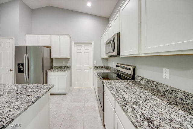 506 NE 2nd Place, Cape Coral, FL 33909 - kitchen with appliances with stainless steel finishes, white cabinetry, light stone counters, light tile patterned flooring, and recessed lighting