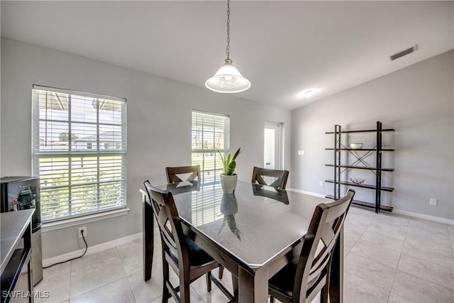 506 NE 2nd Place, Cape Coral, FL 33909 - dining area with lofted ceiling and light tile patterned floors