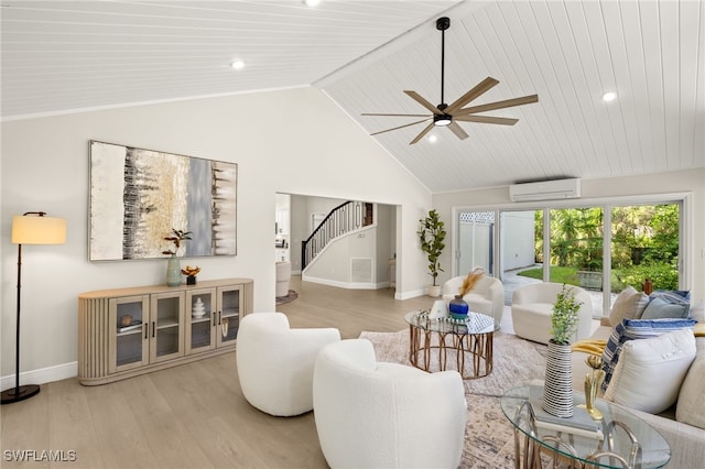 211 11th St NW, Naples, FL 34120 - living room featuring a wall mounted AC, light wood finished floors, stairway, ceiling fan, and high vaulted ceiling