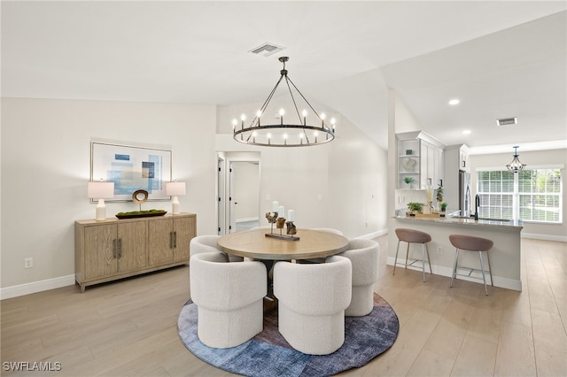 211 11th St NW, Naples, FL 34120 - dining room featuring a chandelier, light wood finished floors, vaulted ceiling, and recessed lighting