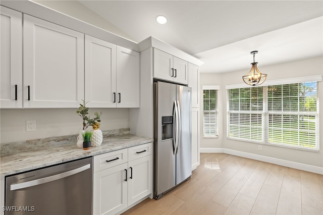211 11th St NW, Naples, FL 34120 - kitchen with stainless steel appliances, white cabinetry, decorative light fixtures, light wood-type flooring, and recessed lighting