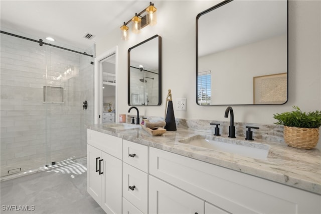 211 11th St NW, Naples, FL 34120 - bathroom featuring double vanity and a shower stall