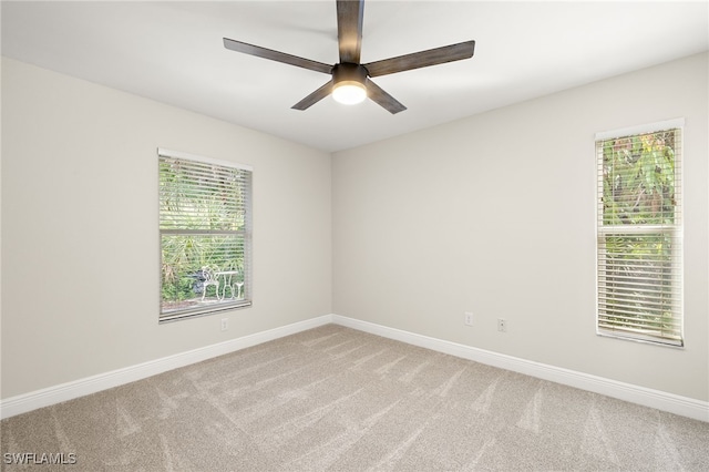 211 11th St NW, Naples, FL 34120 - carpeted spare room with baseboards and a ceiling fan