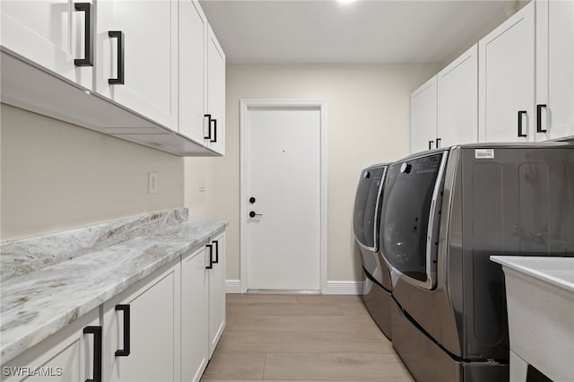 211 11th St NW, Naples, FL 34120 - laundry area with separate washer and dryer, cabinet space, and light wood-style floors