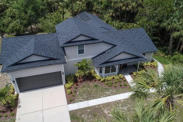 211 11th St NW, Naples, FL 34120 - traditional-style home featuring a shingled roof, an attached garage, driveway, and stucco siding