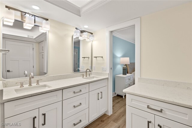 3067 W Gulf Dr Unit 102, Sanibel, FL 33957 - full bath with double vanity, wood finished floors, crown molding, and recessed lighting