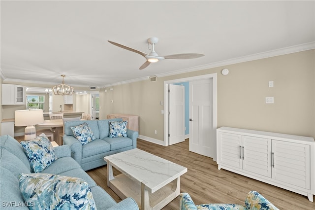 3067 W Gulf Dr Unit 102, Sanibel, FL 33957 - living area with crown molding, wood finished floors, a chandelier, and a ceiling fan