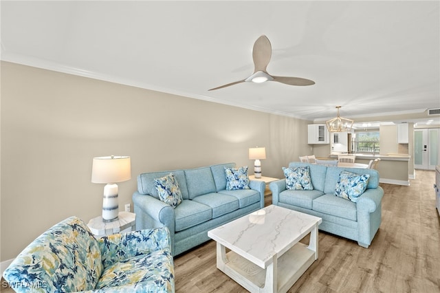 3067 W Gulf Dr Unit 102, Sanibel, FL 33957 - living area with crown molding, light wood-type flooring, a chandelier, and ceiling fan