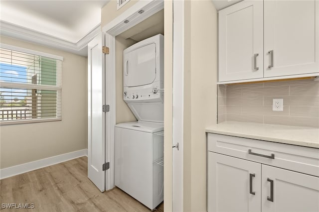 3067 W Gulf Dr Unit 102, Sanibel, FL 33957 - laundry area with stacked washing machine and dryer and light wood-style flooring