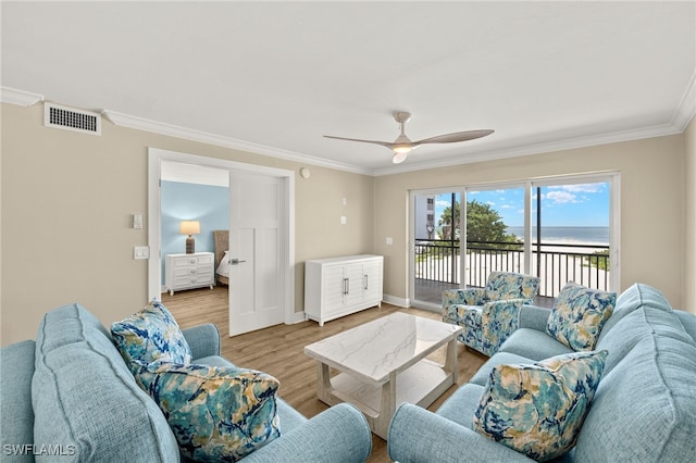 3067 W Gulf Dr Unit 102, Sanibel, FL 33957 - living area featuring ornamental molding, a water view, ceiling fan, and wood finished floors