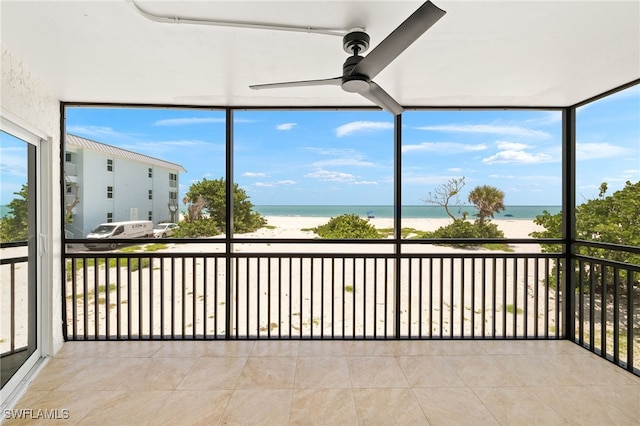 3067 W Gulf Dr Unit 102, Sanibel, FL 33957 - unfurnished sunroom featuring view of water and beach