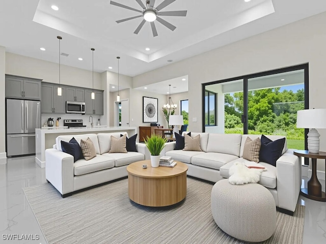 410 Plumosa Ave, Lehigh Acres, FL 33972 - living area with light marble finish floors, recessed lighting, a raised ceiling, ceiling fan, and a high ceiling