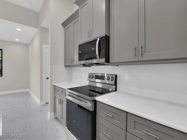 410 Plumosa Ave, Lehigh Acres, FL 33972 - kitchen with stainless steel appliances, gray cabinetry, light marble finish flooring, and recessed lighting