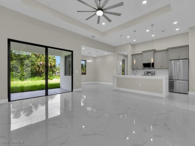 410 Plumosa Ave, Lehigh Acres, FL 33972 - unfurnished living room featuring a ceiling fan, light marble finish flooring, recessed lighting, and a tray ceiling