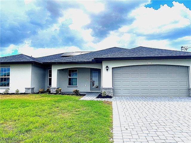 2614 NE 6th Pl, Cape Coral, FL 33909 - single story home with stucco siding, decorative driveway, a front lawn, and a garage