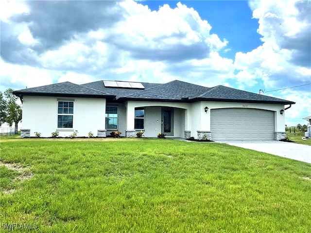 2614 NE 6th Pl, Cape Coral, FL 33909 - view of front facade featuring an attached garage, driveway, solar panels, a front lawn, and stucco siding