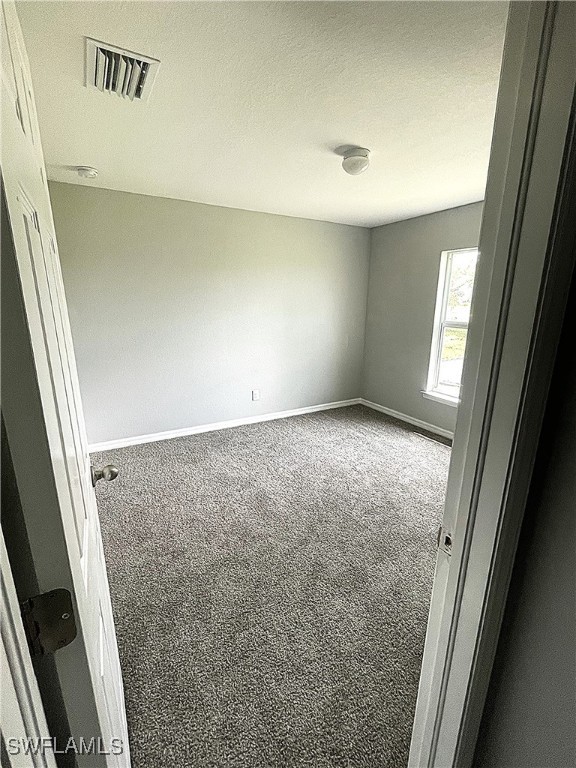 2614 NE 6th Pl, Cape Coral, FL 33909 - carpeted empty room featuring baseboards