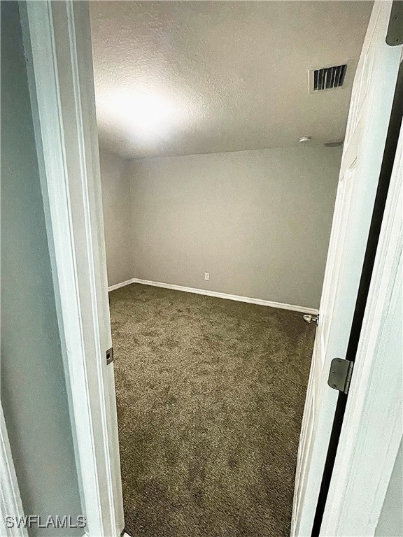2614 NE 6th Pl, Cape Coral, FL 33909 - unfurnished room featuring carpet and a textured ceiling