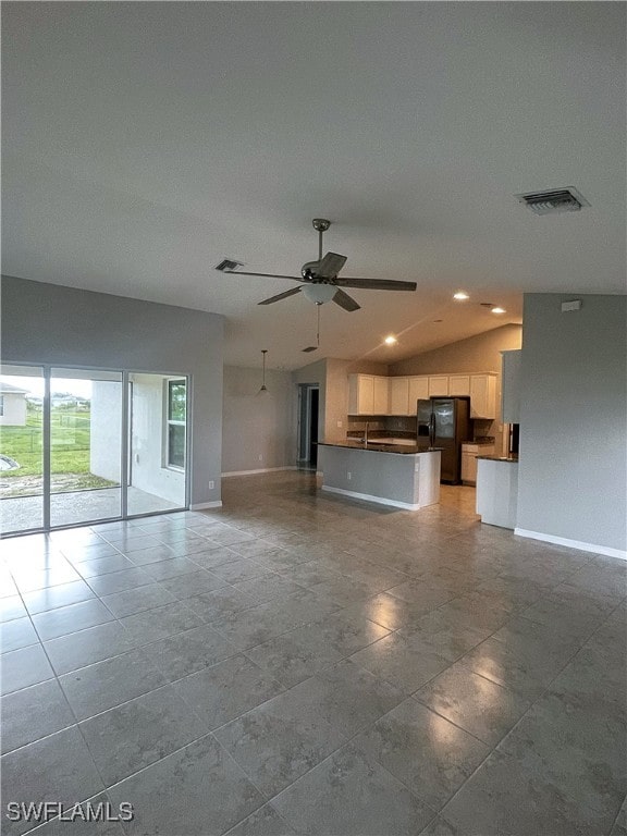 2614 NE 6th Pl, Cape Coral, FL 33909 - unfurnished living room featuring ceiling fan and lofted ceiling