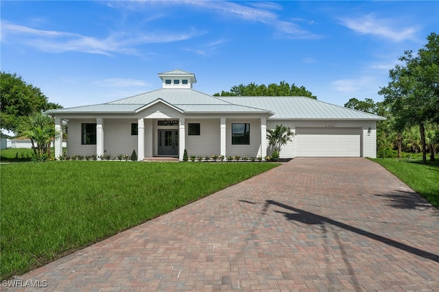 3708 Stagg Ct, Fort Myers, FL 33905 - view of front facade with a standing seam roof, decorative driveway, a front lawn, and an attached garage