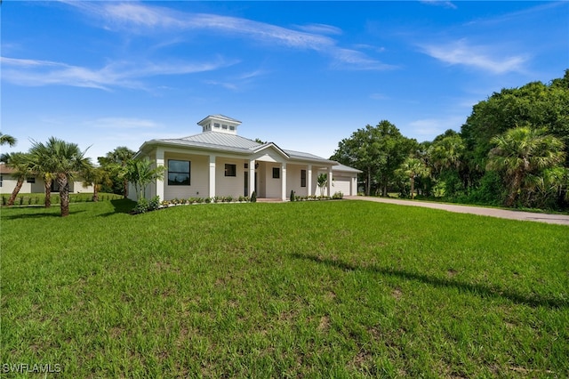 3708 Stagg Ct, Fort Myers, FL 33905 - view of front of house featuring a garage, concrete driveway, covered porch, a front yard, and a standing seam roof