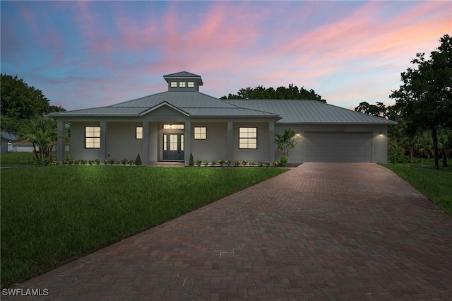 3708 Stagg Ct, Fort Myers, FL 33905 - view of front of house with a standing seam roof, decorative driveway, an attached garage, and a front yard