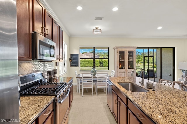 13593 Starwood Ln, Fort Myers, FL 33912 - kitchen with stainless steel appliances, ornamental molding, backsplash, light stone countertops, and recessed lighting