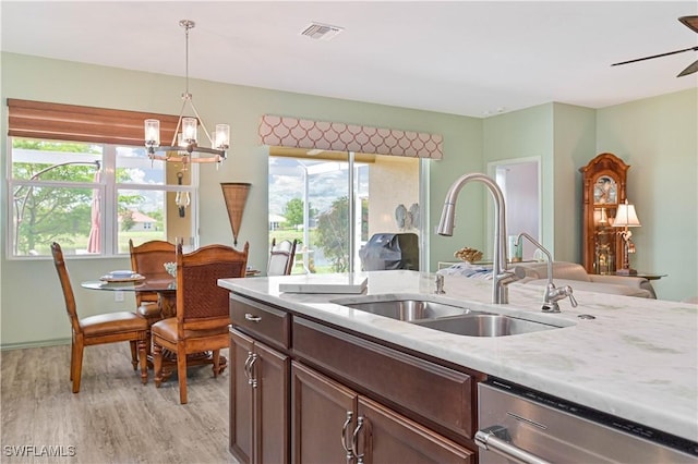 3344 Apple Blossom Dr, Alva, FL 33920 - kitchen with dishwasher, a chandelier, light wood-style flooring, and plenty of natural light