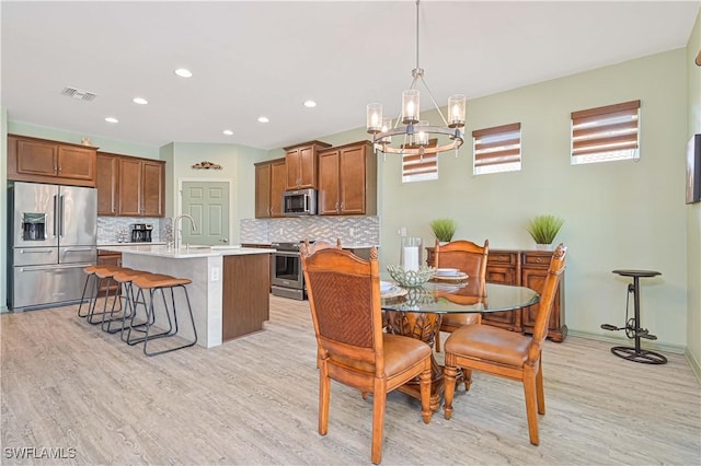 3344 Apple Blossom Dr, Alva, FL 33920 - dining area featuring a chandelier, light wood-style flooring, and recessed lighting