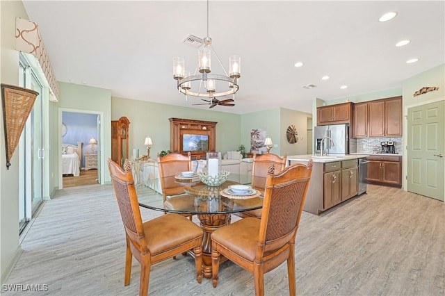 3344 Apple Blossom Dr, Alva, FL 33920 - dining area featuring a chandelier, light wood-style flooring, and recessed lighting