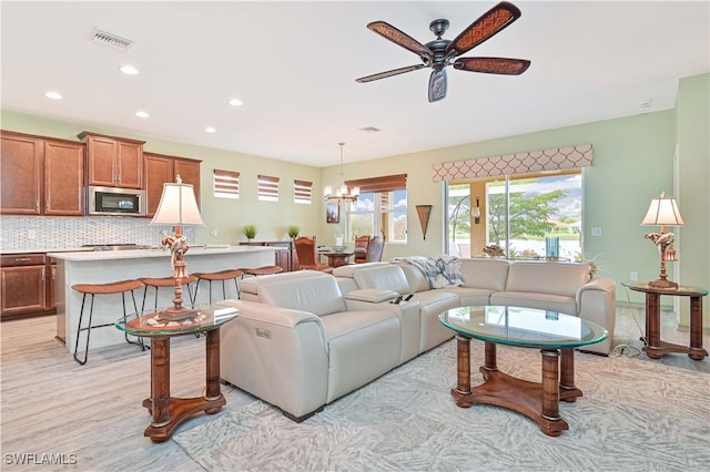 3344 Apple Blossom Dr, Alva, FL 33920 - living room with a chandelier, a ceiling fan, recessed lighting, and light wood-style flooring