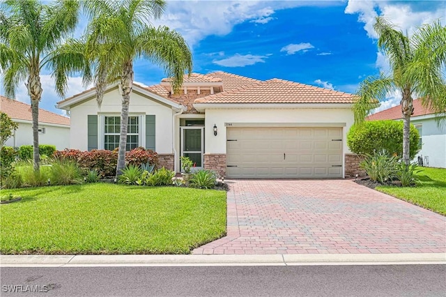 3344 Apple Blossom Dr, Alva, FL 33920 - view of front of house featuring stone siding, stucco siding, an attached garage, and a front yard