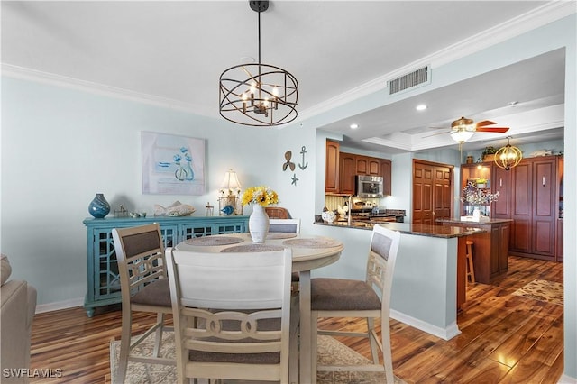 1925 Clifford St Unit 202, Fort Myers, FL 33901 - dining space with a chandelier, dark wood finished floors, crown molding, recessed lighting, and ceiling fan