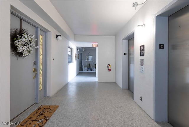 1925 Clifford St Unit 202, Fort Myers, FL 33901 - hallway with dark speckled floor and elevator