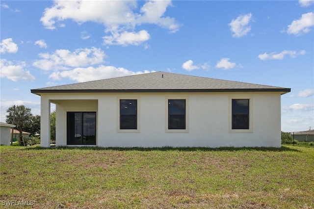 7007 Ramrod Cir, Labelle, FL 33935 - rear view of property with a lawn and stucco siding