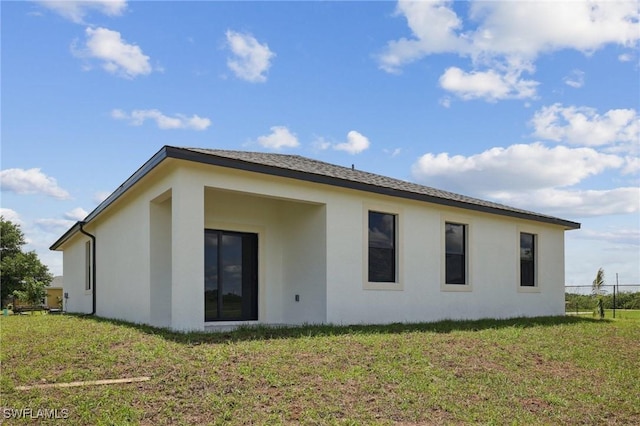 7007 Ramrod Cir, Labelle, FL 33935 - rear view of house featuring stucco siding and a lawn