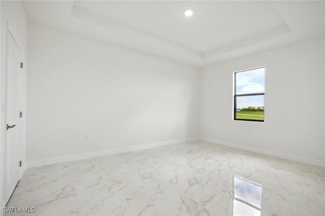 7007 Ramrod Cir, Labelle, FL 33935 - spare room featuring marble look tiles, a tray ceiling, and recessed lighting