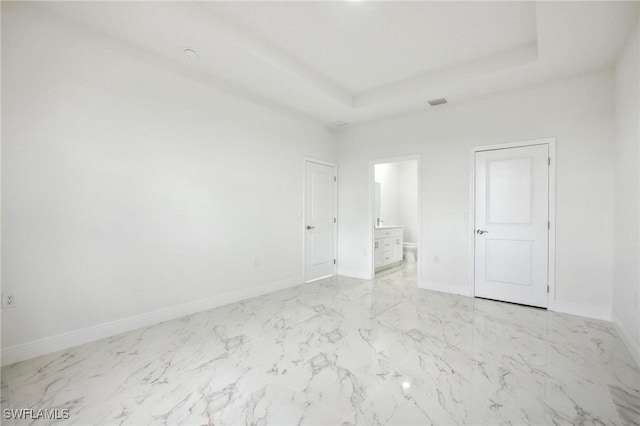 7007 Ramrod Cir, Labelle, FL 33935 - empty room with marble look tile flooring and a tray ceiling